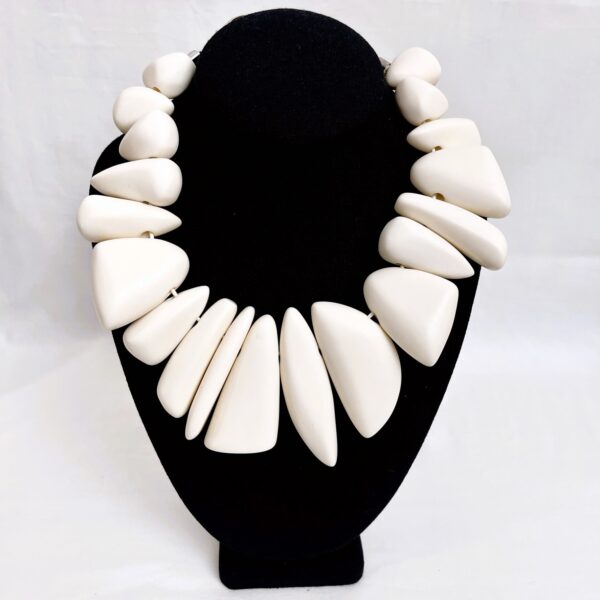 This exquisite chunky necklace features striking large ivory color beads, making it a standout piece for any outfit.
