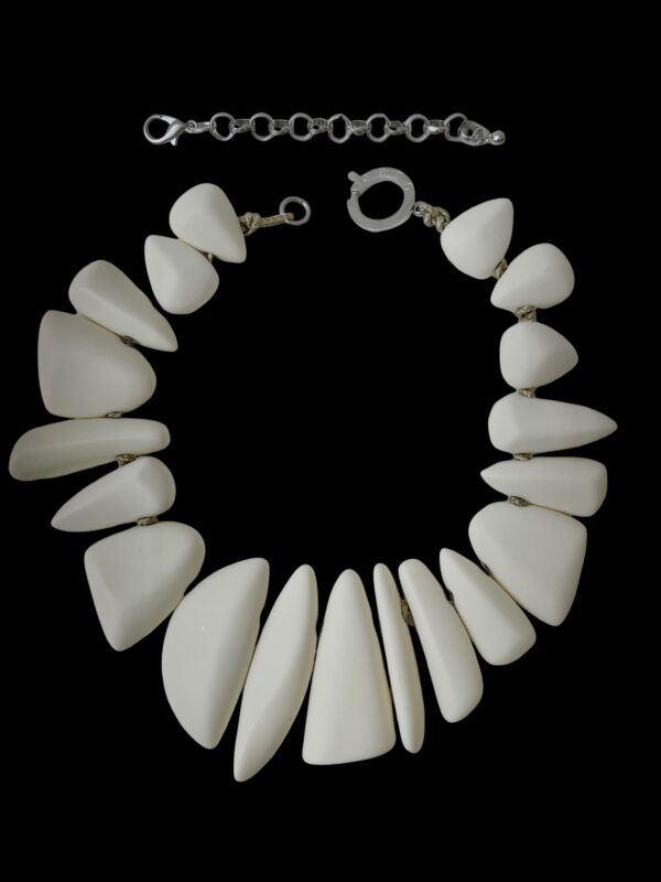 This exquisite chunky necklace features striking large ivory color beads, making it a standout piece for any outfit.