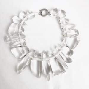 Effortlessly chic and endlessly versatile—the Clear Chunky Necklace brings a fresh, contemporary touch to any ensemble. Measuring 16 inches in length and weighing 9 ounces, this elegant piece strikes the perfect balance between bold presence and everyday wearability. Featuring irregular-shaped clear acrylic beads, the design creates a stunning icicle-like illusion that captures and refracts light with every movement. The lightweight feel and smooth, polished finish of the acrylic ensure comfort throughout the day, while the necklace’s sculptural charm elevates even the simplest outfit. From casual brunches to evening events, it transitions effortlessly—proof that sophisticated style doesn't have to be complicated. For those who appreciate understated drama and flexible fashion, the Clear Icicle Acrylic Necklace is an essential addition to your jewelry rotation. Refined, radiant, and always in season, it’s the kind of piece that quietly transforms your look—like ice catching sunlight, cool and captivating. A chunky necklace can further enhance your unique style.