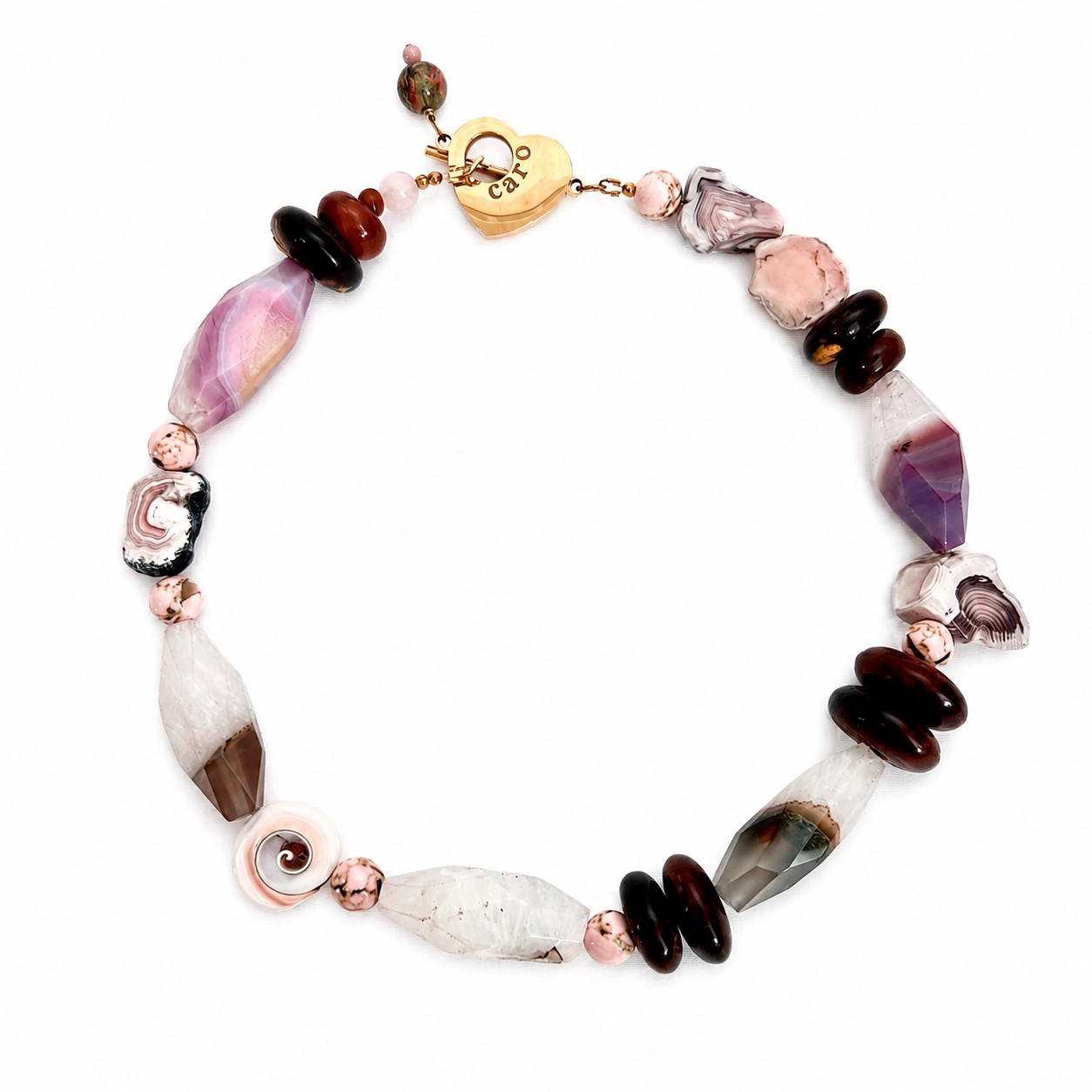 Handcrafted necklace featuring polished pink agate and brown‑toned beads with natural banding patterns, finished with a gold heart clasp engraved “Caro.” The design highlights soft elegance and artisanal detail.