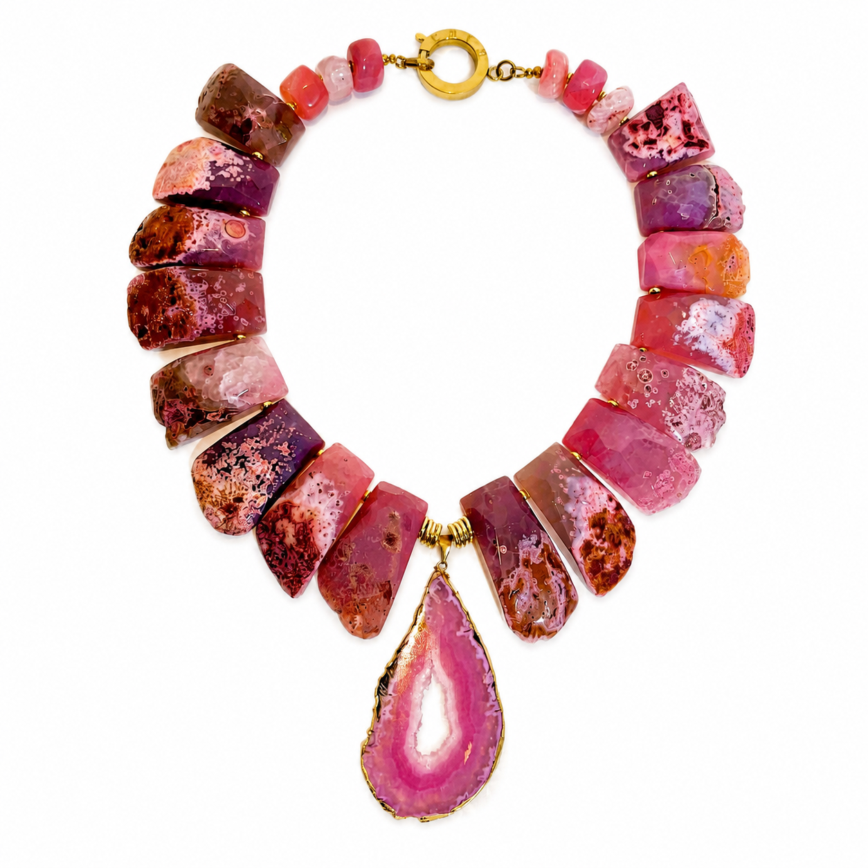 Handcrafted necklace featuring large polished pink agate stones in varying shades of rose and magenta, centered by a teardrop‑shaped agate pendant edged in gold, with a circular gold clasp.