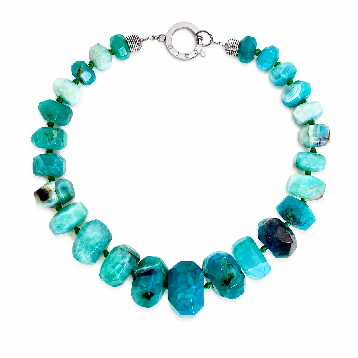 Handcrafted necklace featuring large faceted green agate stones in varying shades of teal and aqua, accented with small green spacers and a silver‑tone clasp engraved “Caro.” The design highlights natural texture and artisanal craftsmanship.