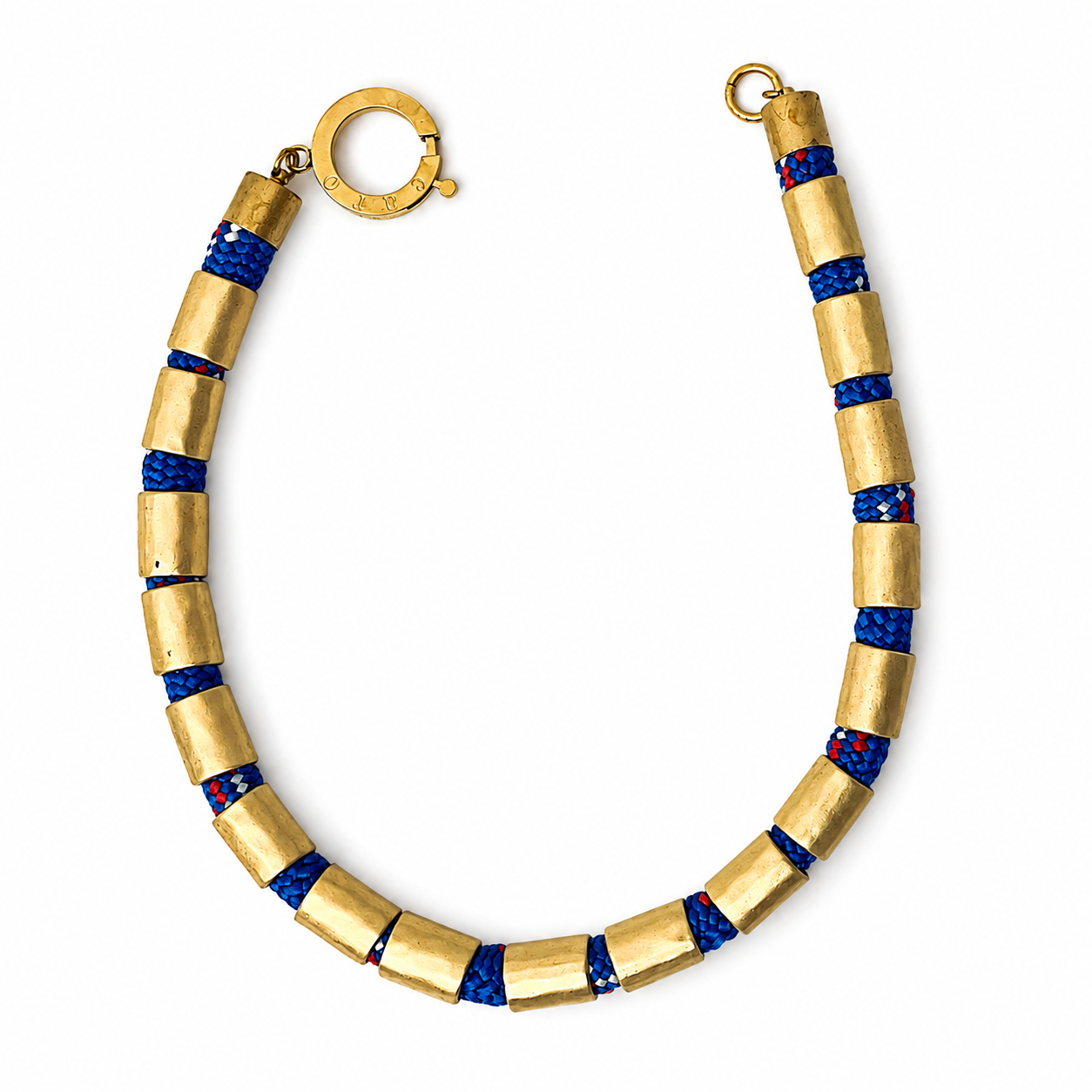 Handcrafted necklace featuring alternating gold cylindrical beads and braided blue rope with red and white accents, finished with a circular gold clasp engraved “Caro.” The design highlights sporty sophistication and refined craftsmanship.