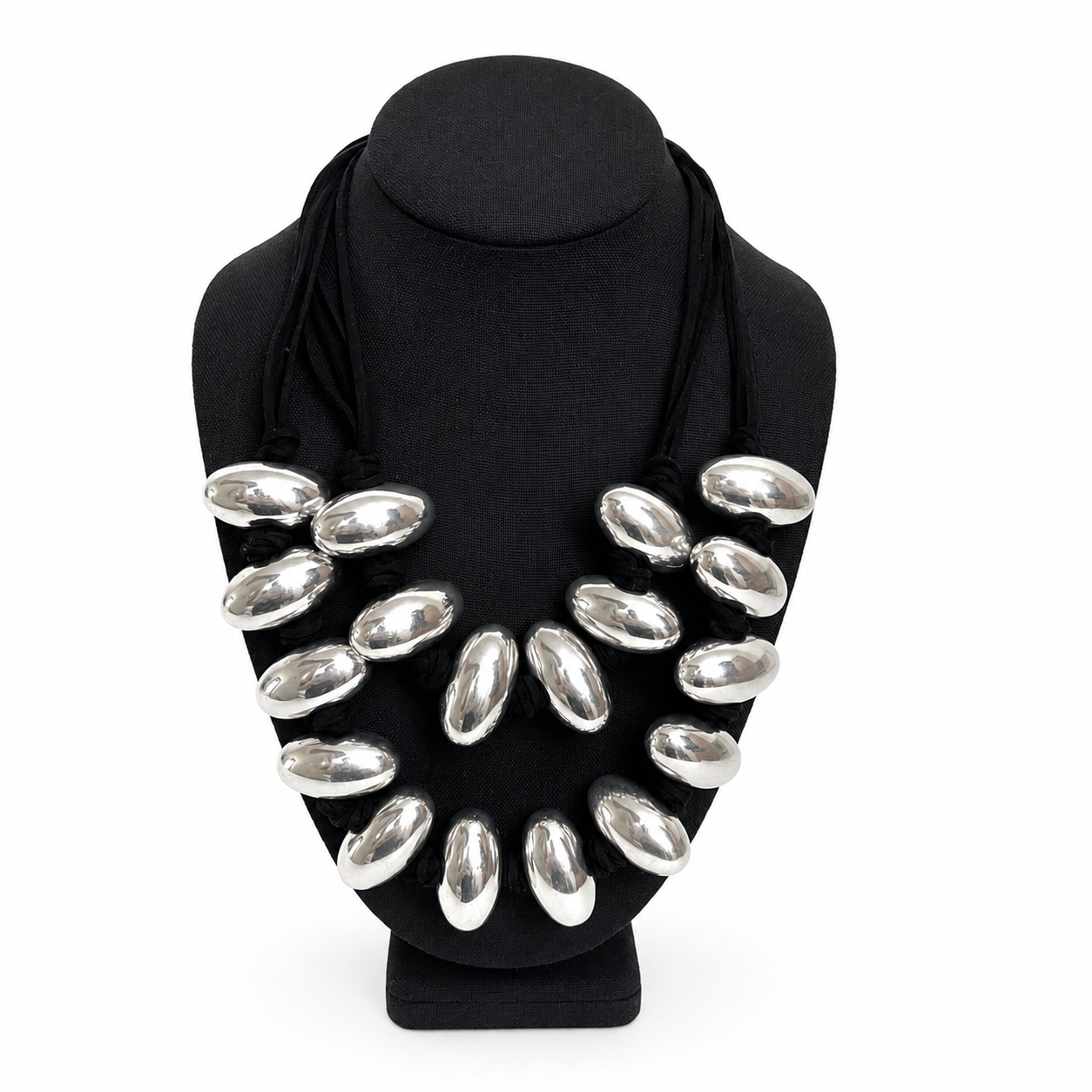 Handcrafted double‑strand necklace featuring polished silver‑tone oval beads strung on a soft black cord, displayed on a black jewelry bust. The design highlights reflective surfaces and layered craftsmanship.