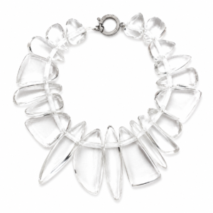 Handcrafted necklace featuring irregular clear acrylic beads arranged in a circular design with a silver‑tone clasp engraved “Caro.” The transparent beads create an ice‑like effect, highlighting modern craftsmanship and minimalist elegance.
