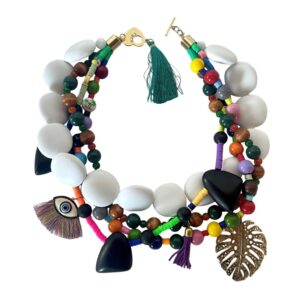 Handcrafted four‑strand necklace featuring multicolor beads in various shapes and finishes, accented with charms including a gold leaf, tassels, and symbolic motifs. The design highlights vibrant craftsmanship and layered elegance.