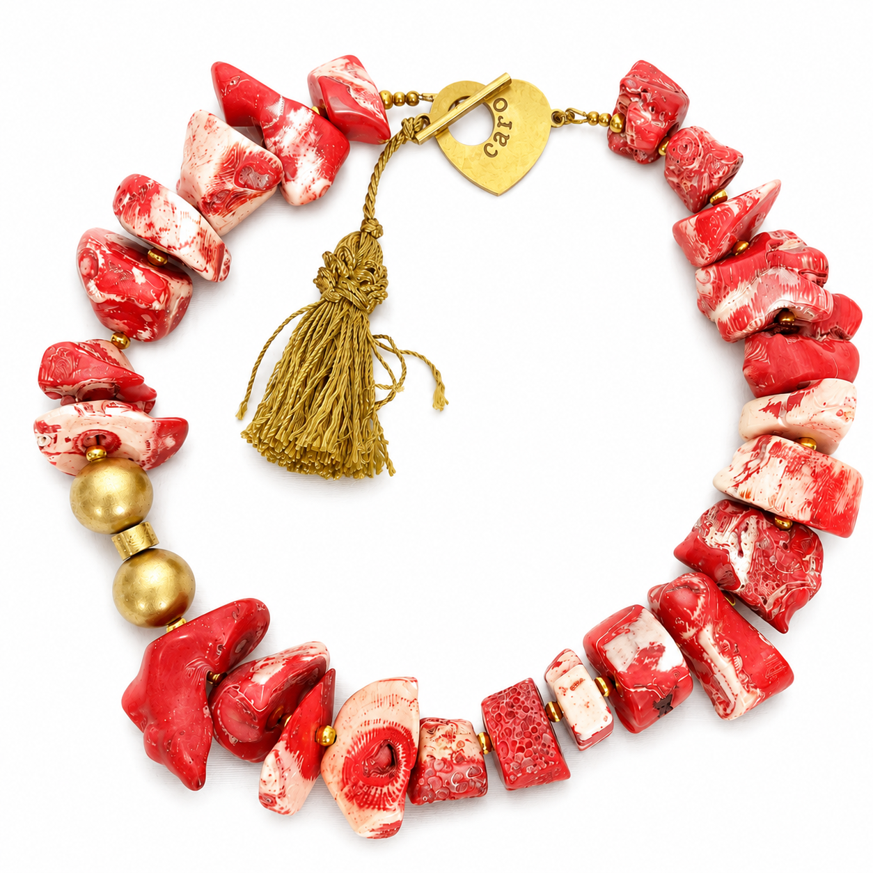 Handcrafted necklace featuring alternating red and white natural coral beads with gold‑colored wooden accents, finished with a gold heart clasp. The design highlights organic texture and vibrant elegance.