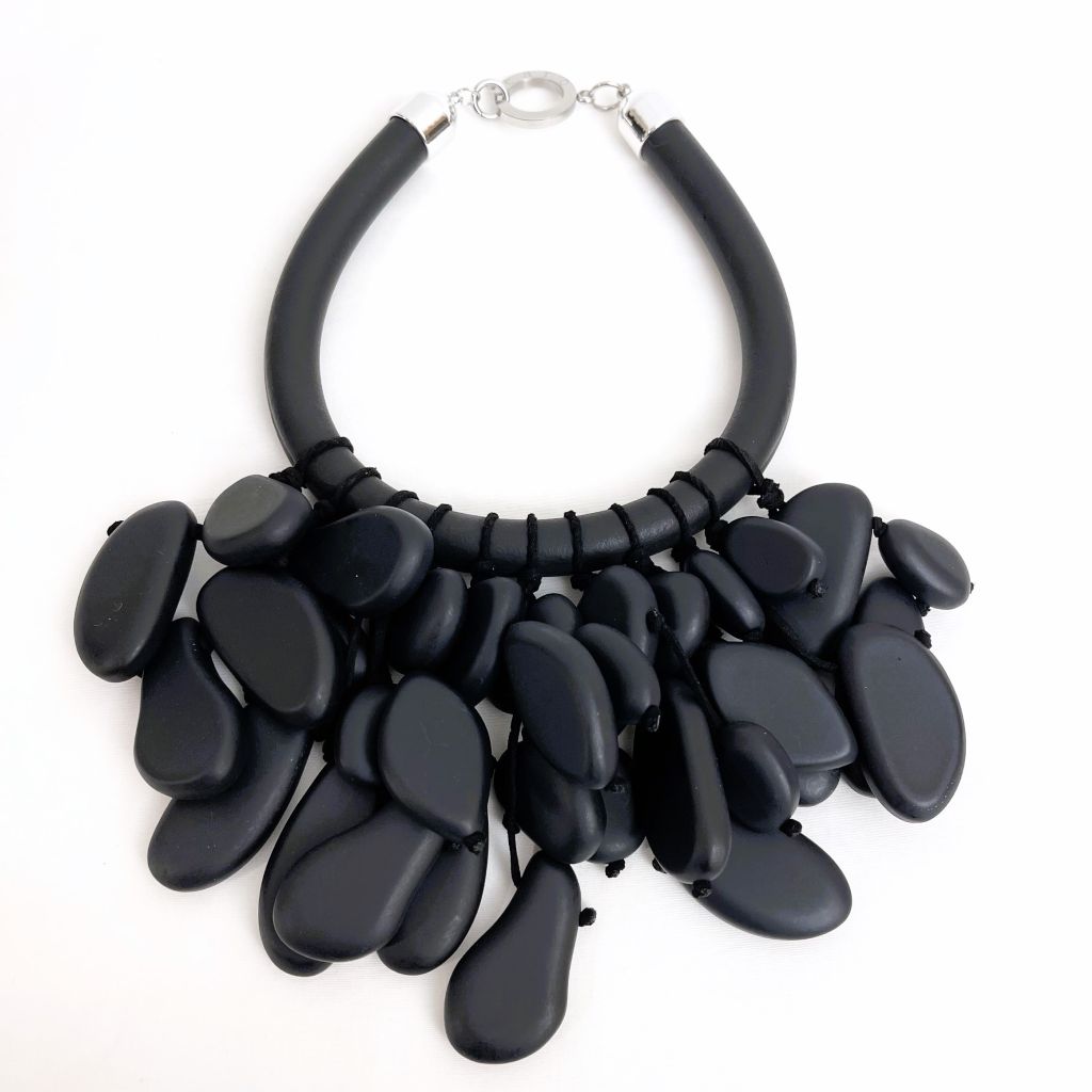 Handcrafted necklace featuring smooth matte black beads arranged in a uniform strand, finished with a secure clasp. The design highlights modern simplicity and sculptural elegance.