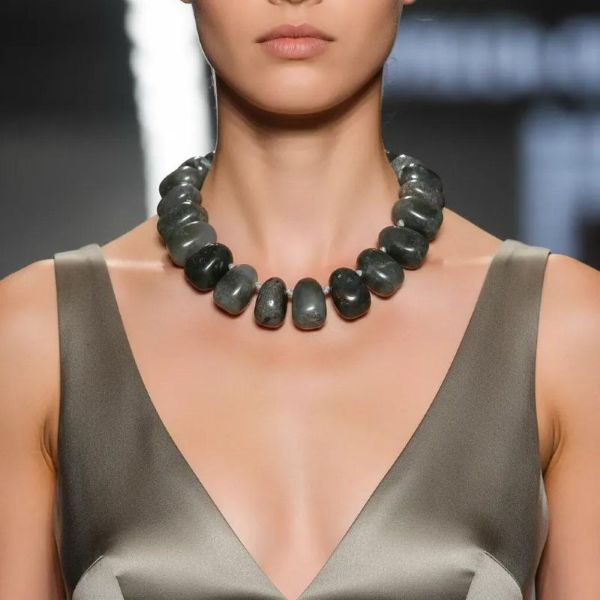 Energy Necklace 0369060 - Command attention and restore energy with the African Blood Stone Necklace—a captivating fusion of natural beauty and holistic function. This handcrafted necklace features a stunning array of African Blood Stone beads, celebrated for their rich hues that range from soft translucent green to deep opaque jade, mottled with flecks of red and shadowy forest tones. The name “Blood Stone” originates from these distinctive red specks, adding historic depth and mystique to the piece. Beyond its aesthetic allure, this necklace is prized for its energetic benefits. As a unique form of quartz, African Blood Stone is believed to encourage balanced energy flow and reduce electromagnetic interference—making it an ideal accessory for those sensitive to static from fabrics, metals, or electronics. Its composition is also thought to help mitigate the effects of Geopathic stress, aligning wellness with wearable art. Comfortably lightweight and versatile in style, this necklace brings grounded elegance to casual outfits and formal attire alike. Whether worn for its metaphysical properties or as a striking visual statement, the African Blood Stone Necklace offers more than adornment—it’s a symbol of balance, strength, and natural sophistication, beautifully designed to support both your style and your spirit.