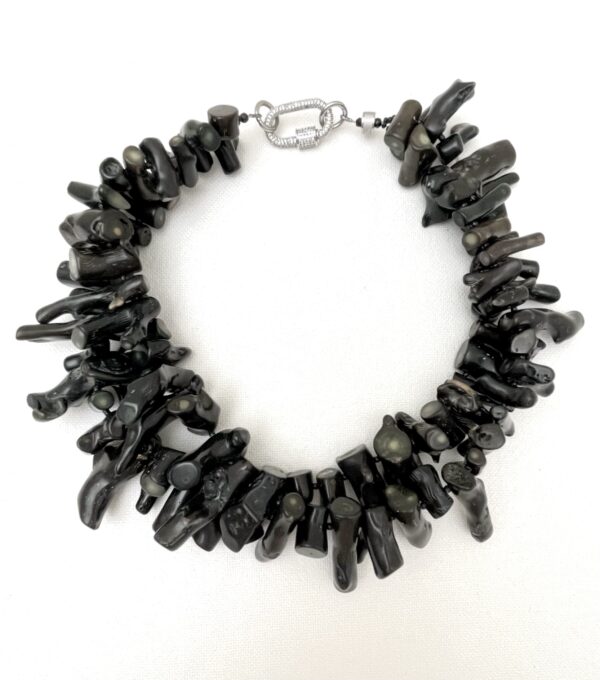 Make an enduring impression with the Double Strand Necklace—a refined creation that balances natural artistry with timeless elegance. This all-natural piece showcases two flowing strands of black coral, each with its own distinctive texture and organic charm. The rich, deep hue and intricate surface of the coral exude understated sophistication, making this necklace a wearable masterpiece for those with an eye for detail and quality craftsmanship. Designed to offer versatility, the double strand necklace silhouette creates a layered effect that’s both graceful and bold. Whether worn solo for a minimalist statement or paired with complementary pieces, it adapts effortlessly to your personal style and occasion. From casual daytime strolls to elegant evening affairs, the necklace transitions seamlessly, offering a polished touch that elevates any ensemble. Each strand reflects the beauty of nature and the care of skilled artisans, blending simplicity and luxury in equal measure. The tactile texture of the coral adds depth and intrigue, while the balanced proportions ensure comfortable wear and visual harmony. For those who value elegance born of nature and elevated by design, the Double Strand Black Coral Necklace is an essential addition—a piece that speaks softly but leaves a lasting impression.