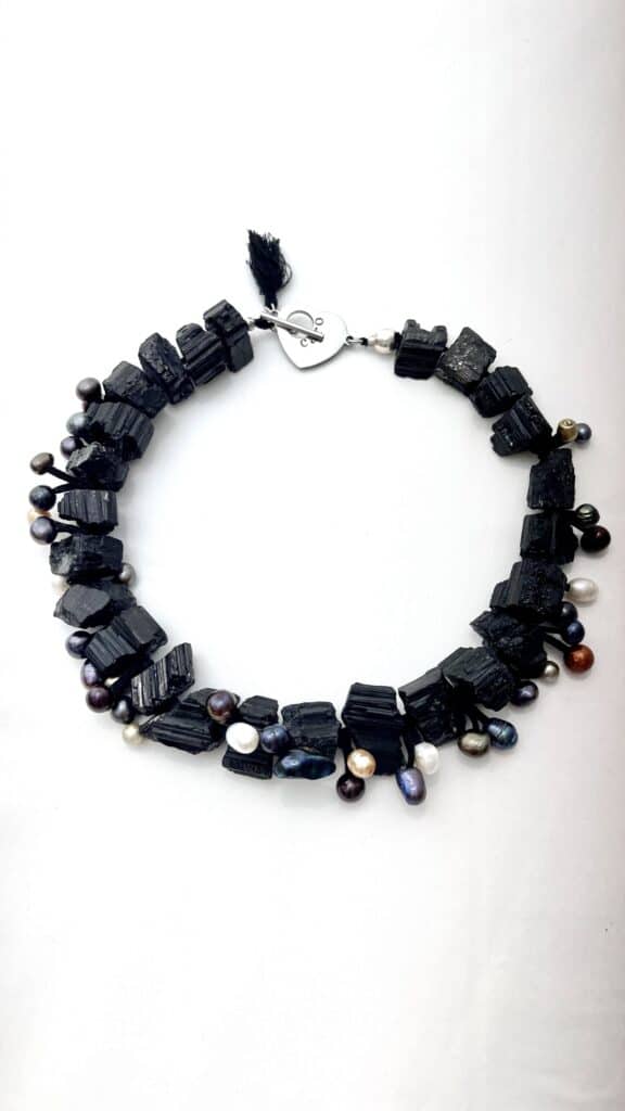 This black necklace features freshwater pearls and natural black Tourmaline, creating a unique art piece to wear.