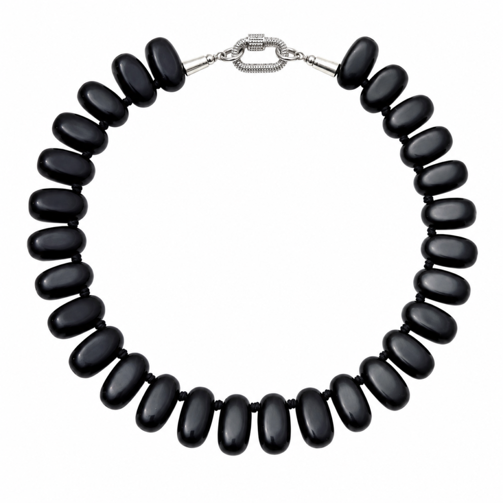 Handcrafted necklace featuring large polished black Obsidian beads with a silver rhinestone carabiner clasp, arranged in a circular formation against a white background.