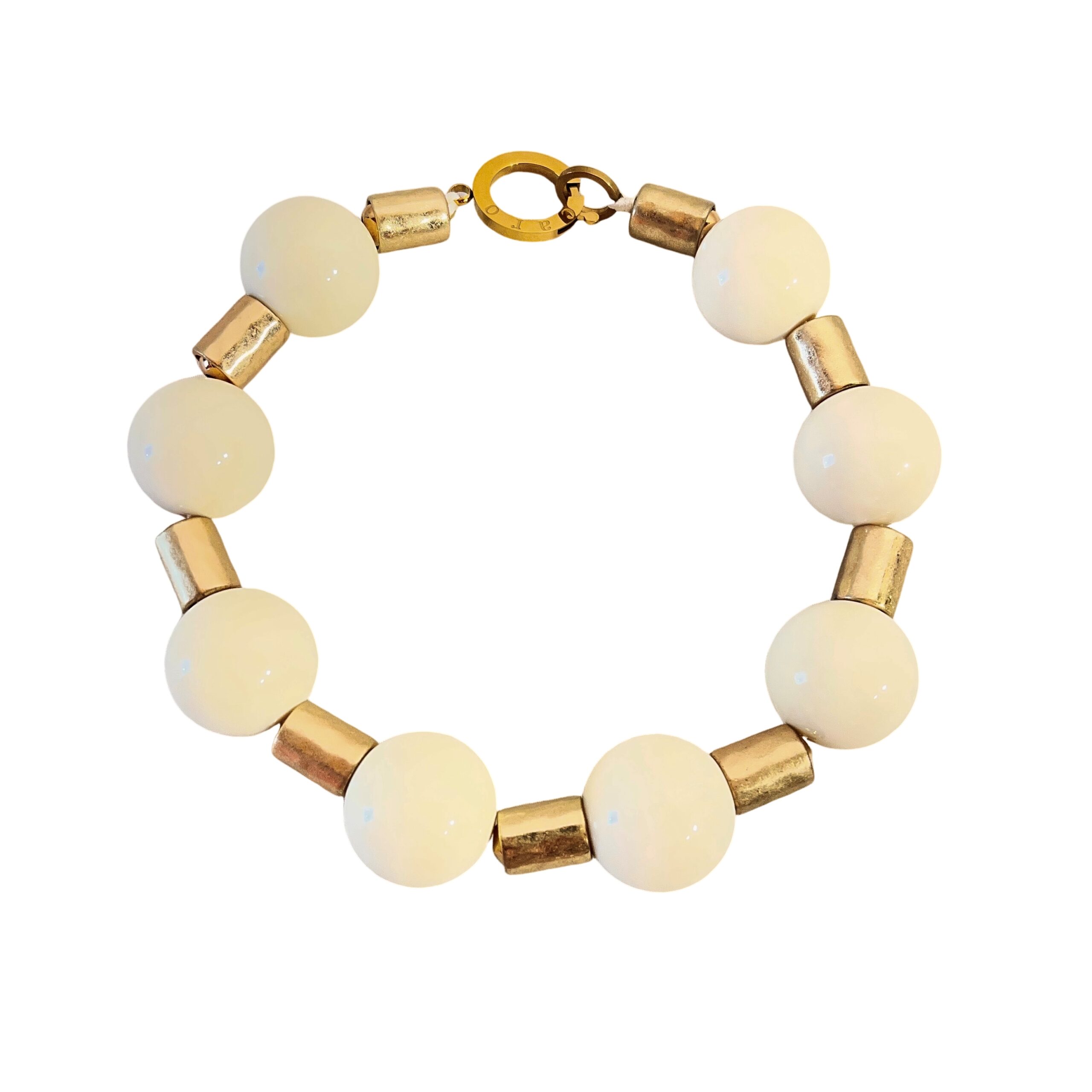 This elegant choker necklace blends classic charm with bold design, featuring large ivory-colored beads that radiate warmth and sophistication. Measuring 17 inches with an extender that allows up to 21 inches of length, it offers a customizable fit for comfort and versatility. Whether worn close to the neck or slightly lower, this piece adapts beautifully to your style. Between each smooth, ivory bead rests an antique gold cylindrical spacer, adding a touch of vintage refinement and enhancing the necklace’s visual rhythm. The contrast between the creamy tones and aged metallic accents creates a timeless aesthetic that complements both modern and traditional wardrobes. A sturdy lobster clasp ensures secure wear while echoing the necklace’s substantial character. The overall weight and balance make it a statement piece without overwhelming your look—perfect for layering or standing alone. Designed for those who appreciate thoughtful details, this necklace celebrates the richness of ivory hues and the allure of antique finishes. Whether you're dressing for a special occasion or elevating everyday attire, its graceful composition and adjustable length make it a go-to accessory. Let the soft glow of ivory and the textured gold spacers tell your story—one of elegance, strength, and enduring beauty.