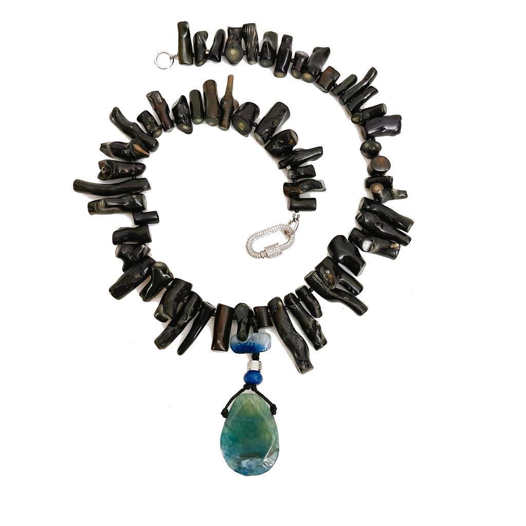 Handcrafted Black Necklace composed of polished black coral beads with a glossy finish and a large teardrop-shaped blue-green pendant. Displayed on a white background, emphasizing its organic texture, silver clasp, and refined craftsmanship.