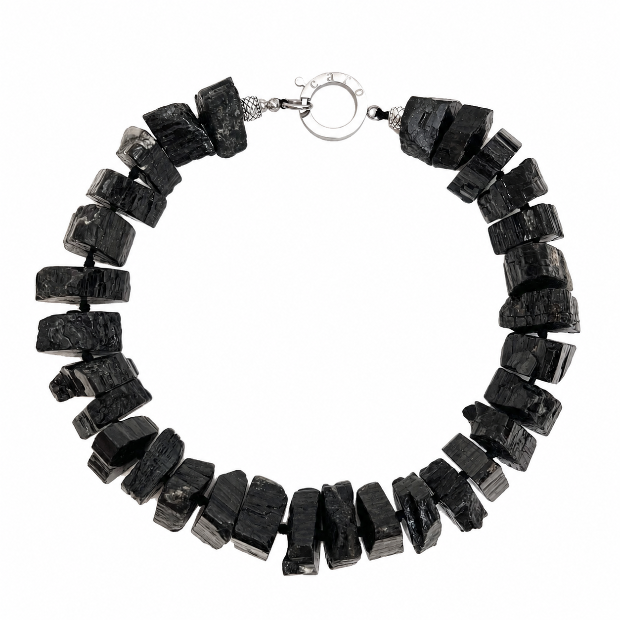 Handcrafted Tourmaline Necklace composed of large, irregular black tourmaline stones with a silver clasp engraved “Caro.” Displayed on a white background, emphasizing the necklace’s rough texture, organic form, and artisanal craftsmanship.