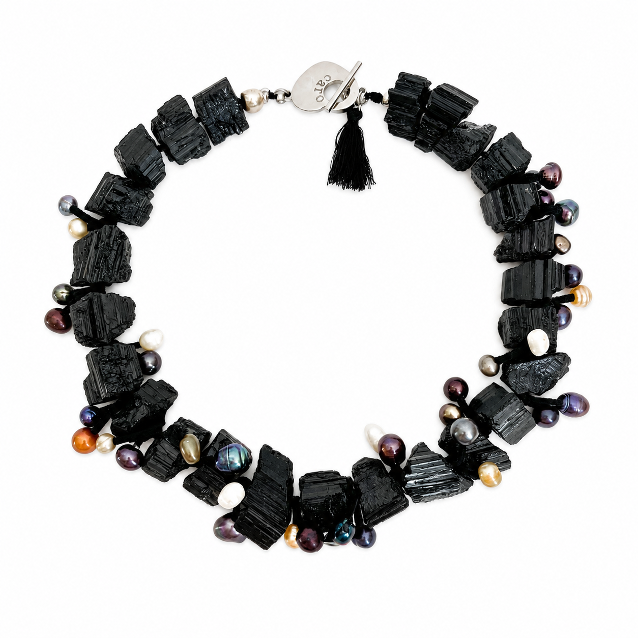 Black tourmaline and freshwater pearl aromatherapy statement necklace with silver toggle clasp and black tassel on a white background.