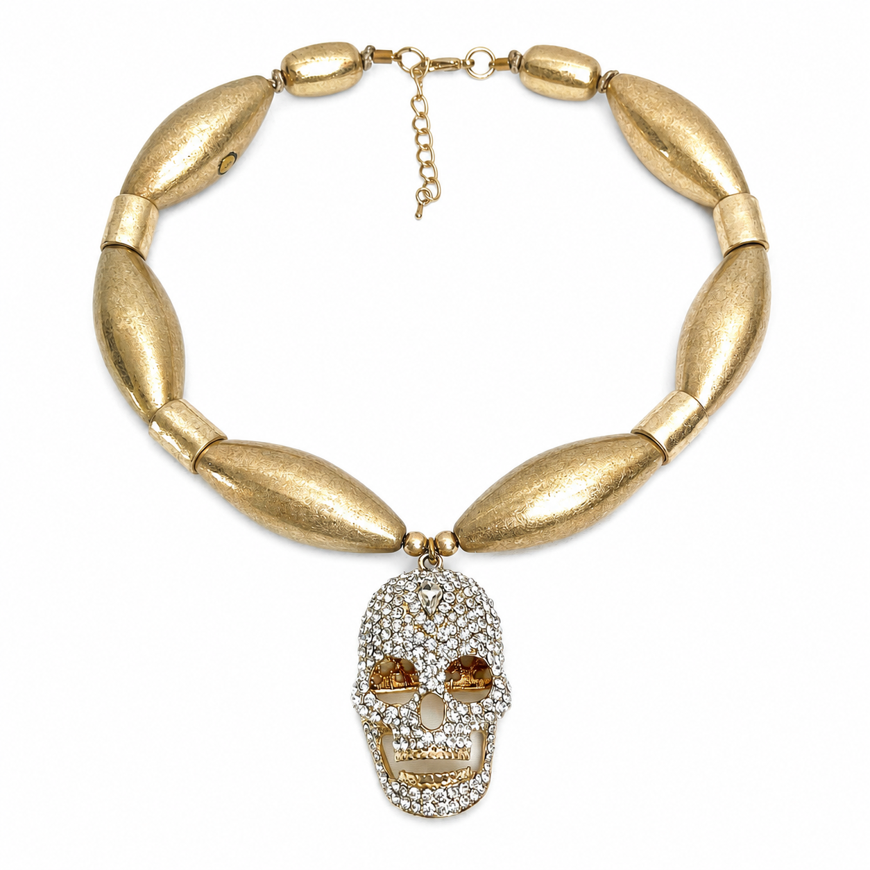 Caro Original skull necklace featuring elongated matte gold beads and a jeweled skull pendant with amber eyes and a movable jaw.