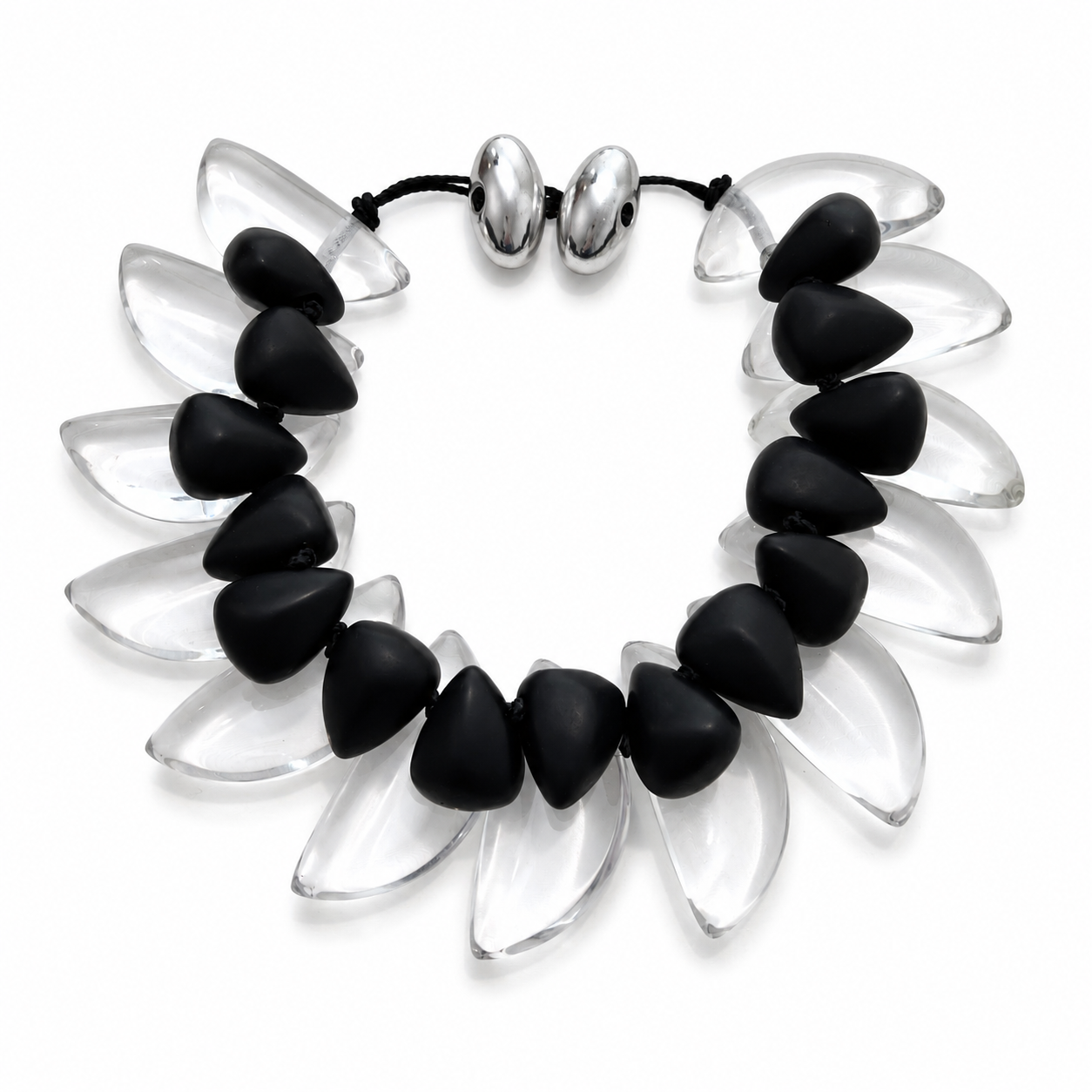Statement necklace featuring alternating matte black and clear crescent‑shaped beads arranged in a collar design with silver clasp, displayed on a white background.