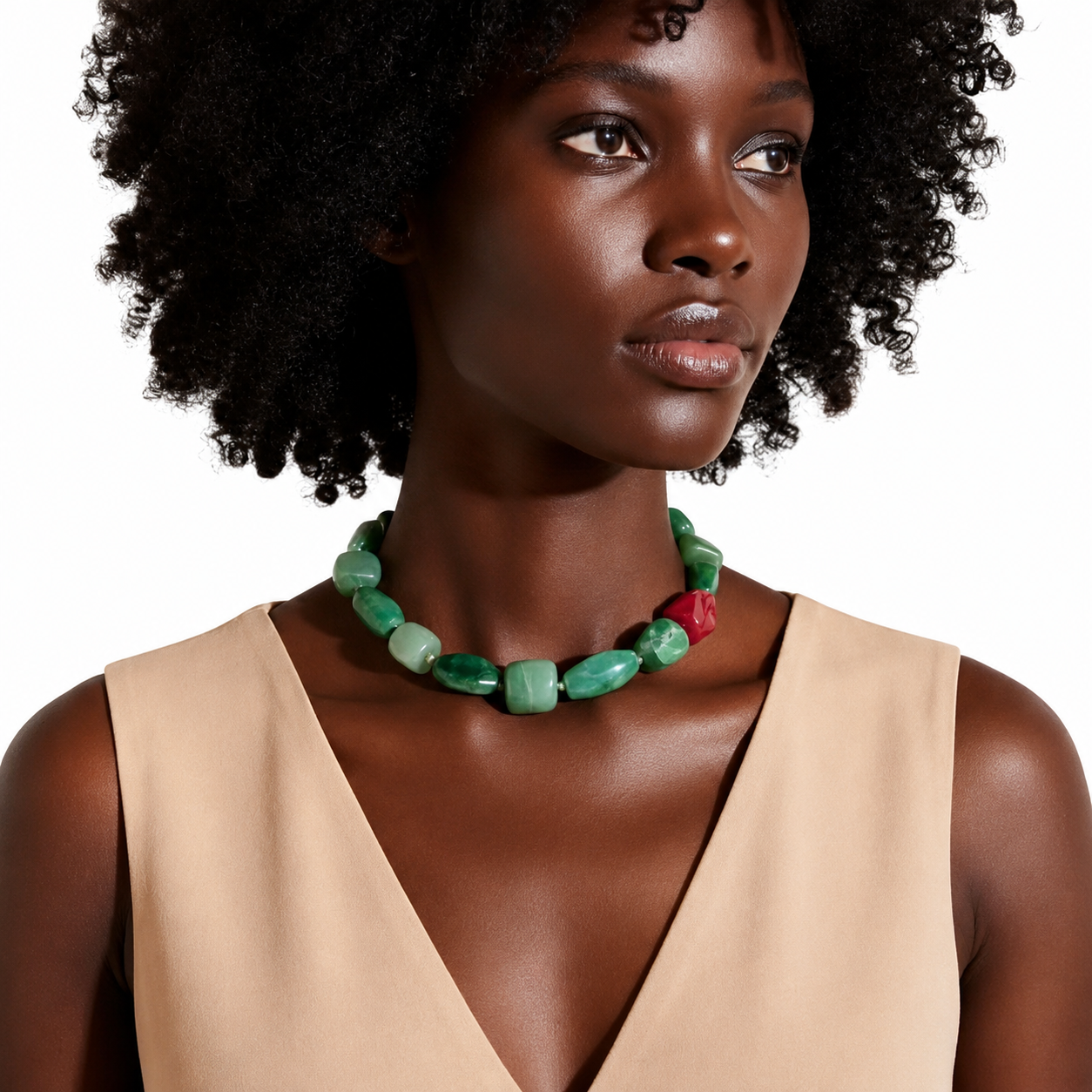 Model wearing a minimalist green Aventurine choker with a pink Agate accent bead, styled with a sleeveless beige V‑neck dress in soft natural light.