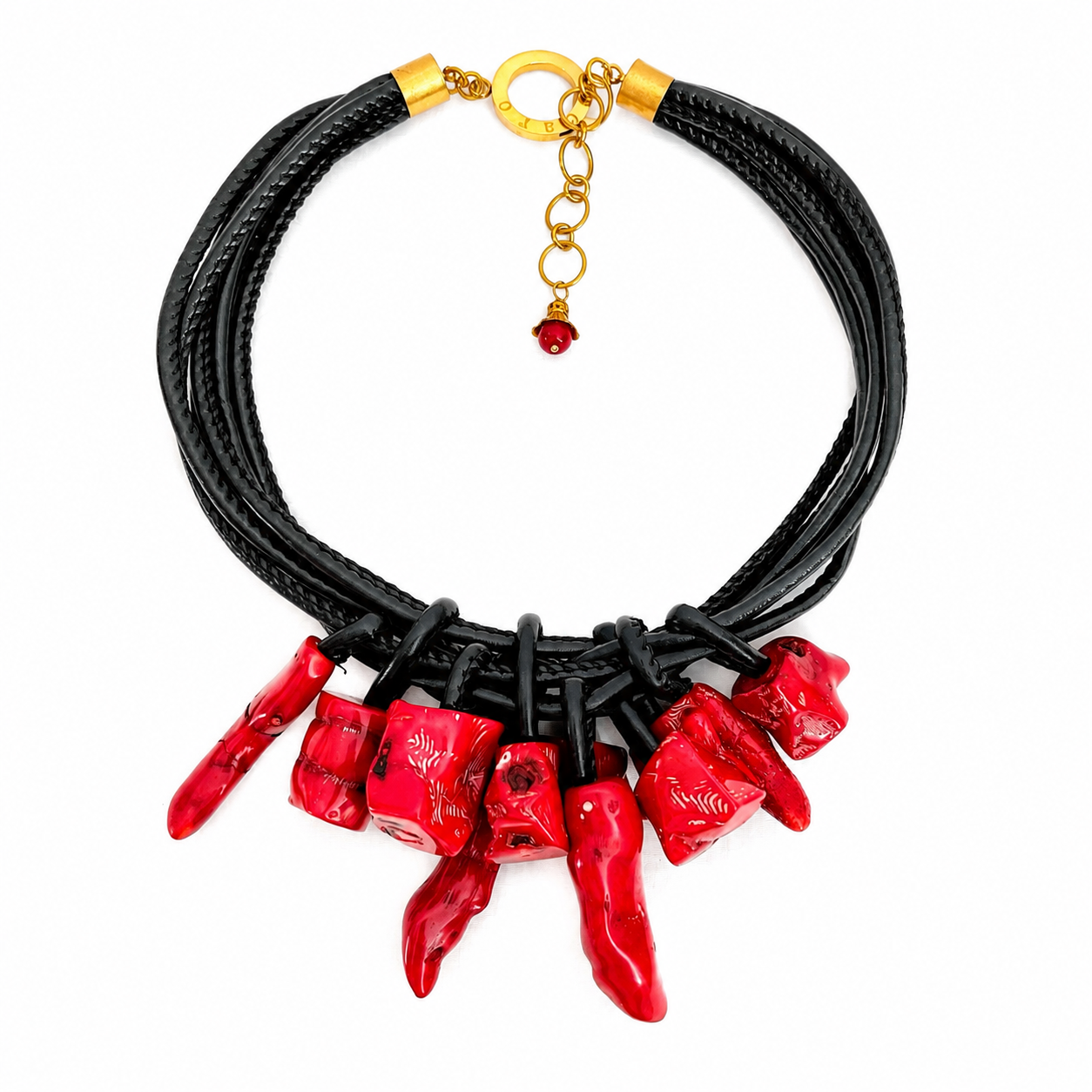 Handcrafted necklace featuring irregular red coral pendants attached to multiple black vegan leather cords with gold clasp and chain extension, displayed on a white background.
