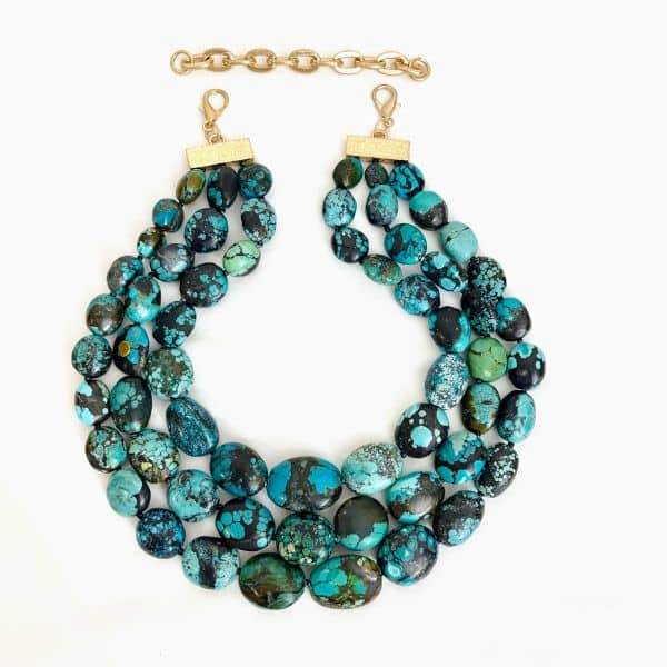 Rooted in history and radiant in style, the Genuine Green Turquoise  Necklace brings ancient elegance into the modern wardrobe. This exquisite piece features multiple strands of untreated, all-natural green turquoise stones—each bead showcasing its own unique mineral patterns that celebrate the raw beauty of the earth’s earliest treasure. Known as the first gemstone mined by humans as far back as 5000 BCE, turquoise carries a legacy of spiritual symbolism and artisanal craftsmanship. Designed in a choker or collar style, the Turquoise Necklace includes a subtle extension for adjustable comfort, allowing it to adapt gracefully to different necklines and occasions. The layered composition enhances its visual presence, giving depth and movement to the richly hued green stones while maintaining an air of refined simplicity. Perfect for lovers of heritage pieces with contemporary flair, this necklace bridges past and present through texture, tone, and meaning. Whether worn with linen, leather, or sleek modern silhouettes, the Turquoise Necklace adds timeless allure and cultural resonance to any ensemble. More than a fashion statement, the Genuine Green Turquoise Multi-Strand Necklace is a celebration of nature’s artistry and humanity’s enduring love affair with stone.