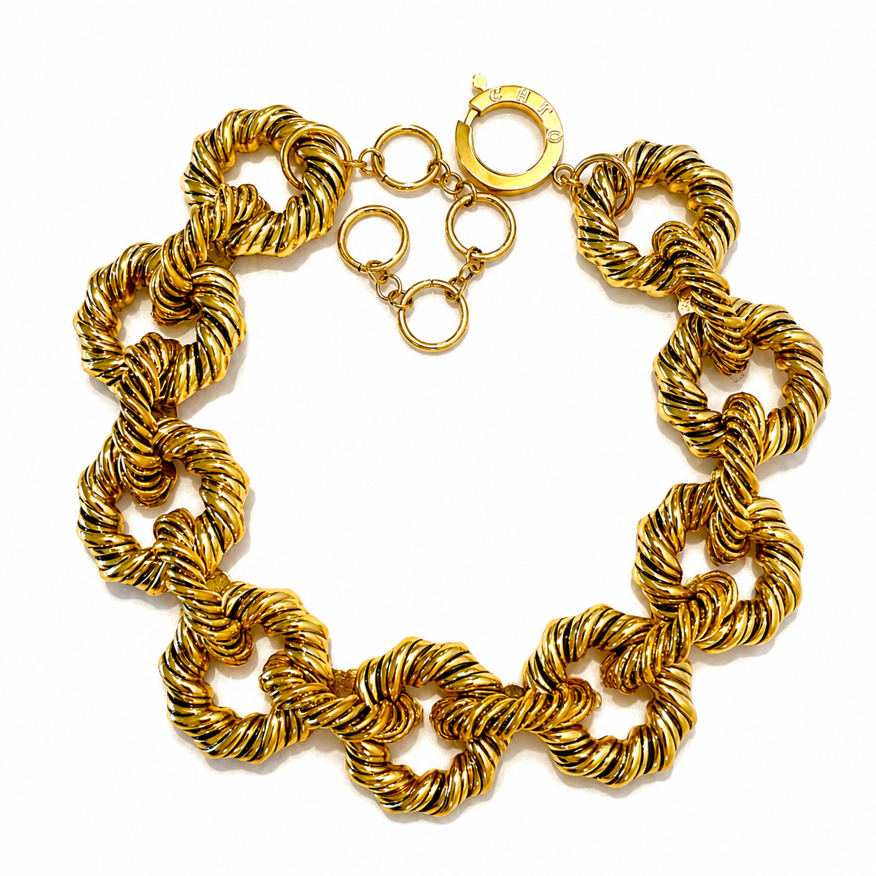 Chunky gold rope‑link necklace featuring large twisted circular links and adjustable clasp engraved “Caro,” displayed on a white background.
