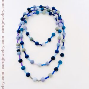 Long necklace measuring 37 inches long made of soft silicon beads in blue colors