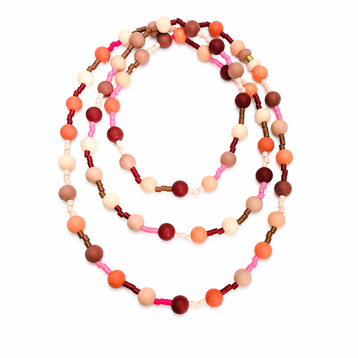 Long necklace composed of round and cylindrical silicone beads in warm shades of peach, pink, cream, brown, and orange, arranged in a repeating pattern and displayed on a white background.