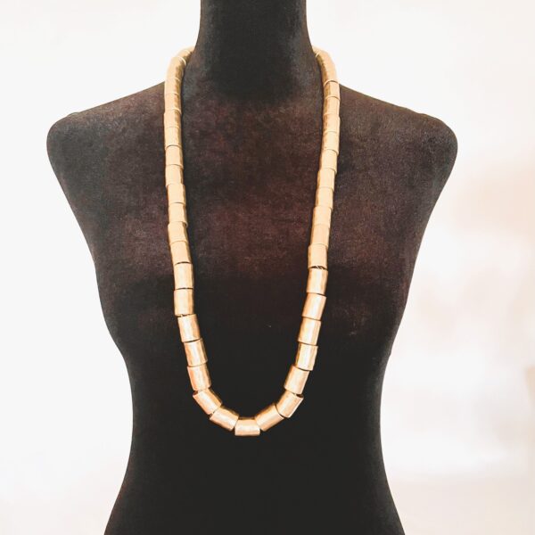 Edgy with refinement, this punk long-style punk necklace is a bold nod to rebellion—crafted with a dash of sophistication. Measuring 33 inches (84 cm), its generous length makes it effortlessly versatile, flowing with grace for both daytime defiance and nighttime glam. Whether draped over denim or paired with sleek tailoring, it redefines punk as poised and intentional. A series of antique gold cylindrical beads form the heart of its punk design, channeling grit through gleaming elegance. These metallic accents lend an industrial vibe softened by their vintage luster, creating a dynamic contrast between raw attitude and curated style. It's punk—but with class. What truly sets this necklace apart is the subtle tension between form and finish. The choice of tones, bead shape, and extended length infuses the punk piece with movement and personality. It's perfect for those who walk the line between statement and subtlety, for those who embrace individuality with polish. Wear it layered, looped, or standalone—it’s your personal manifesto, wrapped in gold-toned attitude, you can add a touch of punk to your style, but with elegance.