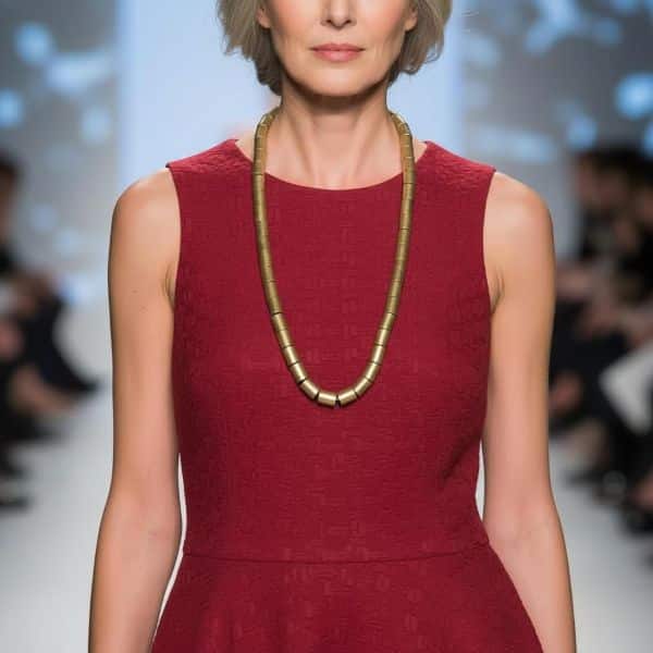 Edgy with refinement, this long-style punk necklace is a bold nod to rebellion—crafted with a dash of sophistication. Measuring 33 inches (84 cm), its generous length makes it effortlessly versatile, flowing with grace for both daytime defiance and nighttime glam. Whether draped over denim or paired with sleek tailoring, it redefines punk as poised and intentional. A series of antique gold cylindrical beads form the heart of its design, channeling grit through gleaming elegance. These metallic accents lend an industrial vibe softened by their vintage luster, creating a dynamic contrast between raw attitude and curated style.  The cylindrical beads have texture, and the shape breaks down the traditional smooth shape. What truly sets this necklace apart is the subtle tension between form and finish. The choice of tones, bead shape, and extended length infuses the piece with movement and personality. It's perfect for those who walk the line between statement and subtlety, for those who embrace individuality with polish. Wear it layered, looped, or standalone—it’s your personal manifesto, wrapped in gold-toned attitude, you can add a touch of punk to your style, but with elegance.