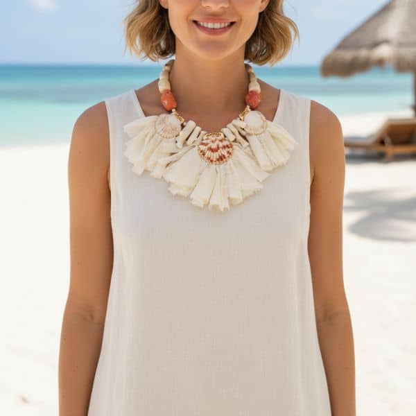 Effortlessly graceful and undeniably unique, this exquisite necklace invites nature’s charm into everyday elegance. Measuring 18 inches (46 cm), its versatile length makes it ideal for casual brunches, seaside strolls, sun-drenched garden parties, and cruise trips. Every natural element is thoughtfully curated to evoke tranquility and warmth. Soft peach-hued natural seashells reflect the calm of early dawn, while delicate soft orange coral infuses a gentle vitality into the palette. Pristine white coral adds balance and purity, grounding the design with its crisp contrast. These natural materials are strung along a supple ivory ribbon, which enhances the overall softness and lends a refined, handcrafted touch. This is a mild summer statement necklace for daytime parties or night pool parties. With its harmonious blend of color and texture, this mild summer piece is more than a necklace—it’s wearable art. It speaks to those who find beauty in subtlety and craftsmanship in simplicity. Whether peeking from beneath a linen collar or accenting a flowy dress, it enhances any outfit with understated sophistication. Let it be your daytime signature, a reminder of natural elegance and the quiet power of thoughtful design.