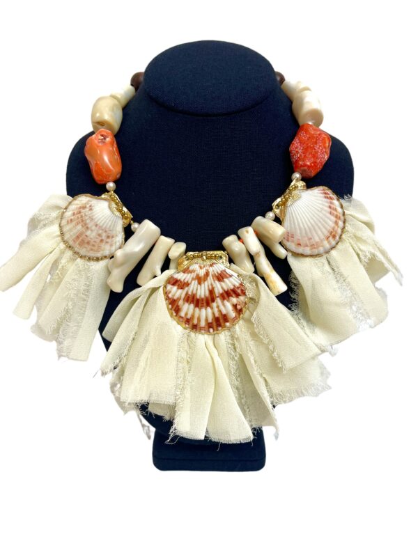 Soft peach colors of natural sea shells, soft orange Coral, natural white Coral, and ivory ribbon.  The necklace measures 18 INC/46 CM long.