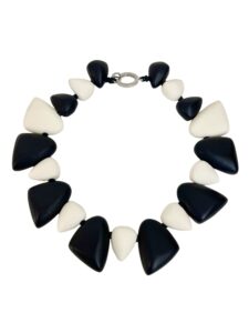 Classic Black and Ivory collar-style chunky necklace. Resin large beads. 21 INC/53 CM, 9 OZ. The beads form a circular shape, and the necklace will maintain its shape.