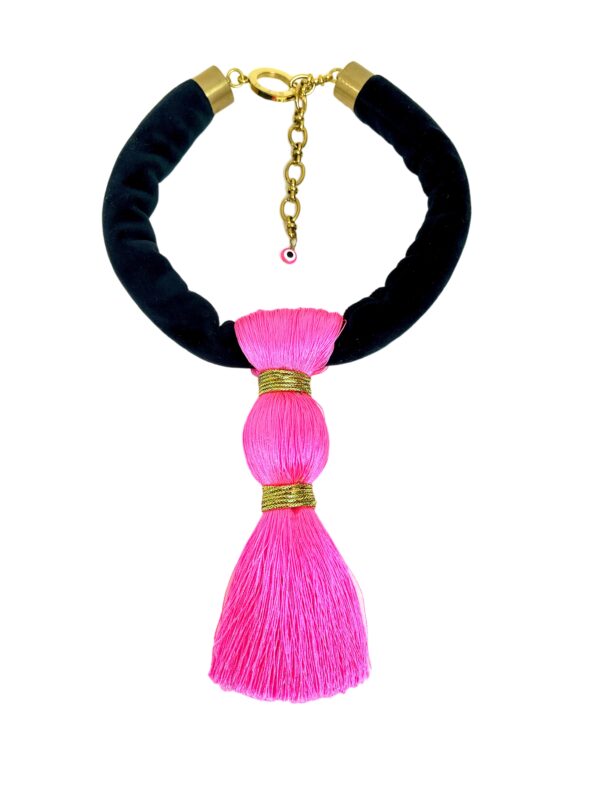 Bold, playful, and effortlessly chic—this striking pink and black necklace is the accessory your black wardrobe’s been waiting for. Measuring 17 inches (43 cm) and weighing a mere 3 ounces, it blends comfort with unforgettable style. The soft black suede cord lies smoothly against the skin, while the oversized hot pink tassel, crafted from luxe silk thread and bound in shimmering gold, steals the spotlight. Perfect for those who love wearing black but want to add a vibrant twist, the tassel’s vivid hue injects instant energy into your ensemble. Whether you're dressing up a casual tee or adding flair to an evening look, this piece is a standout companion. The tassel sways gracefully with movement, catching the light and attention alike—making it more than an accessory; it’s a statement of joyful confidence. Designed for effortless wear, its lightweight construction and punchy color palette make it ideal for both day-to-night transitions and seasonal layering. A must-have in any expressive collection, this necklace invites you to redefine black with a pop of personality. Let it hang loose, speak loud, and celebrate your style with every swing.
