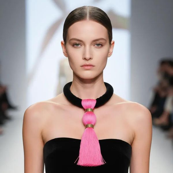 Bold, playful, and effortlessly chic—this striking pink and black necklace is the accessory your black wardrobe’s been waiting for. Measuring 17 inches (43 cm) and weighing a mere 3 ounces, it blends comfort with unforgettable style. The soft black suede cord lies smoothly against the skin, while the oversized hot pink tassel, crafted from luxe silk thread and bound in shimmering gold, steals the spotlight. Perfect for those who love wearing black but want to add a vibrant twist, the tassel’s vivid hue injects instant energy into your ensemble. Whether you're dressing up a casual tee or adding flair to an evening look, this piece is a standout companion. The tassel sways gracefully with movement, catching the light and attention alike—making it more than an accessory; it’s a statement of joyful confidence. Designed for effortless wear, its lightweight construction and punchy color palette make it ideal for both day-to-night transitions and seasonal layering. A must-have in any expressive collection, this necklace invites you to redefine black with a pop of personality. Let it hang loose, speak loud, and celebrate your style with every swing.