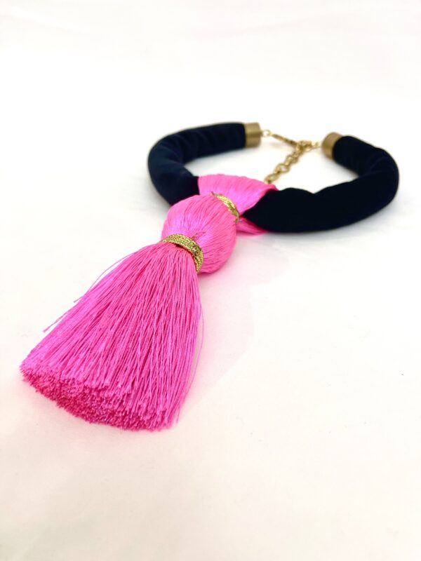 A pop of color for any occasion. The oversized tassel and the hot pink color bring life to any black attire. Made of suede cord and silk thread, the necklace is lightweight and soft on the skin. The necklace measures 17 INC/43 CM, 3 OZ.