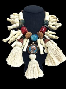 An exotic combination of natural stones, tassels, a wood medallion, brass horses, Coral, Bone, glass, Labradorite, Apatite, and sandalwood.  The necklace measures 19 INC/46 CM, 19 OZ.