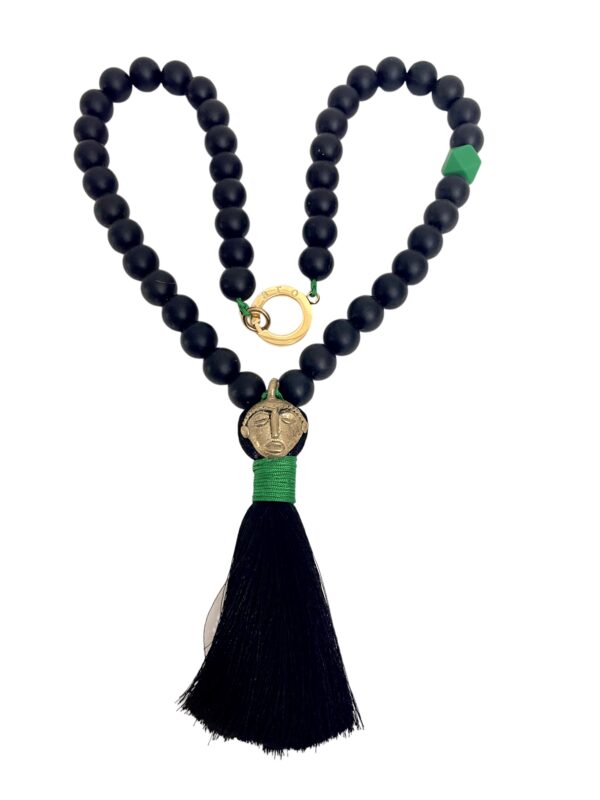 Tribal style long necklace made of black silicone beads, brass pendant, and silk tassel.  Simple and elegant accessory, lightweight, and easy to travel with.  The necklace measures 18 INC/46CM, 5 OZ.
