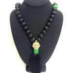 Tribal style long necklace made of black silicone beads, brass pendant, and silk tassel.  Simple and elegant accessory, lightweight, and easy to travel with.  The necklace measures 18 INC/46CM, 5 OZ.