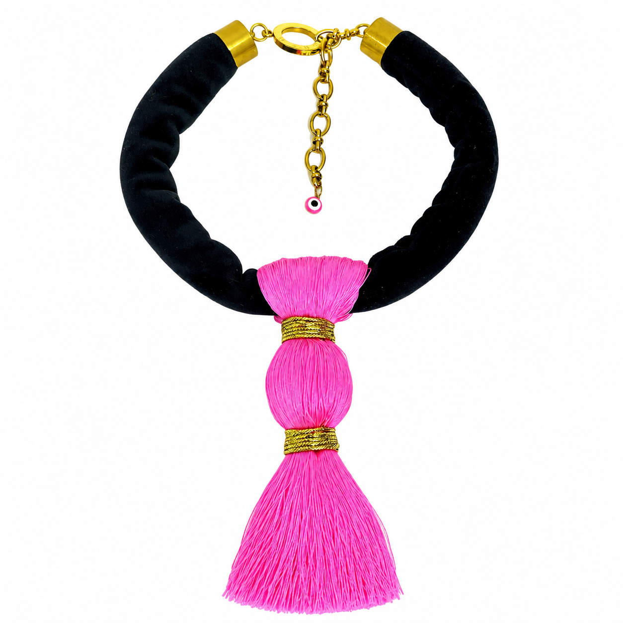 Statement necklace featuring a thick black suede cord with gold metal ends and a large hot pink silk tassel centerpiece. The tassel is composed of three sections bound with gold thread, creating a bold and luxurious contrast.