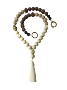 Long statement necklace made of cream and chocolate color silicone beads with a large irregular-shaped pendant.  Classic warm colors with gold accents.  Simple yet, elegant for everyday use and easy to travel with.  The necklace measures 28IN/8OZ.