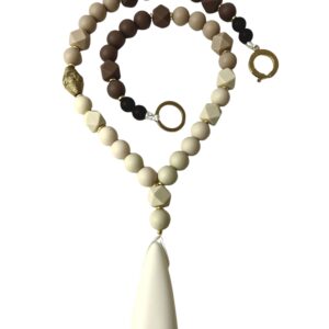 Long statement necklace made of cream and chocolate color silicone beads with a large irregular-shaped pendant.  Classic warm colors with gold accents.  Simple yet, elegant for everyday use and easy to travel with.  The necklace measures 28IN/8OZ.