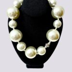 Statement necklace of oversized simulation pearls.  A distinctive look with a one-of-a-kind choker necklace.  The size of the beads makes the necklace elegant for night-time and fun for day-time.  The necklace measures 22 IN/12 OZ