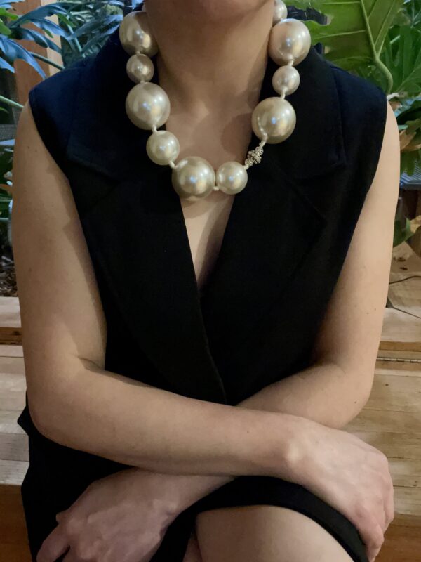 Statement necklace of oversized simulation pearls.  A distinctive look with a one-of-a-kind choker necklace.  The size of the beads makes the necklace elegant for night-time and fun for day-time.  The necklace measures 22 IN/12 OZ