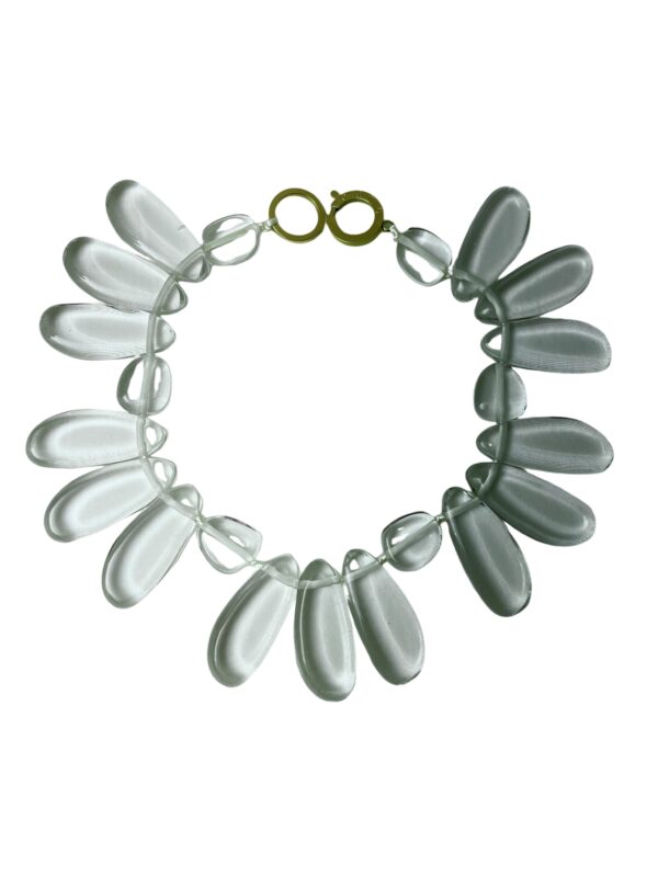 This playful design is shaped like a flower with clear petals.  Lightweight and made of flattened beads,  the necklace is comfortable to wear all day.  The clear beads are versatile to wear with any color and are easy to use to dress up or down an outfit.  The necklace measures 19IN/12OZ.