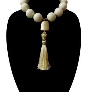 Exotic ivory color round acrylic beads with gold tiger head and silk tassel tongue pendant.  It is a classic color with an elegant accent bead to make a statement.  The necklace measures 18IN/11OZ and can extend up to 24IN.