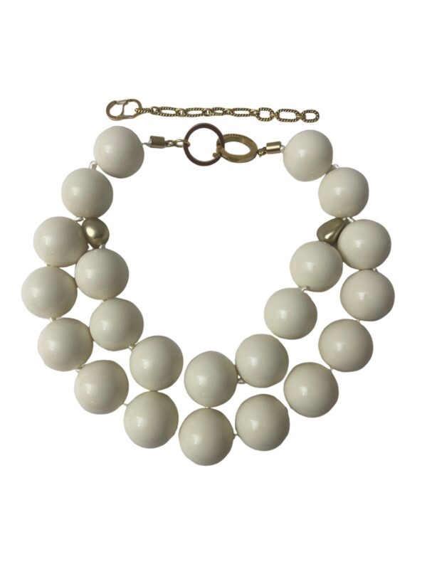 Double-strand oversized acrylic beads in ivory color and two small gold accent beads make this a classic statement necklace for corporate attire. The ivory beads are easy to combine with various fabric colors. The necklace measures 19 IN/12 OZ and includes an extender to make it up to 24 IN long.