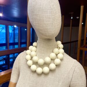 Double-strand oversized acrylic beads in ivory color and two small gold accent beads make this a classic statement necklace for corporate attire. The ivory beads are easy to combine with various fabric colors. The necklace measures 19 IN/12 OZ and includes an extender to make it up to 24 IN long.