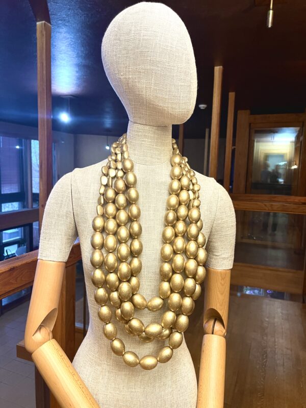 This versatile four-strand necklace can be detached and worn alone or in combination.  The beads are oval in antique gold, and the clasp is two carabines for easy opening and closing.  The longest strand is 42 inches; combined strands weigh 32 ounces.  Wearing all four strands makes a showpiece, and wearing only one makes a unique look.  You can order one strand at no additional cost and specify the length.