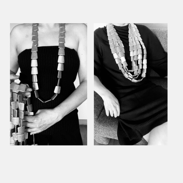 Ingots Necklace Elevate your style with this stunning multi-strand necklace, meticulously crafted from irregular antique gold beads in the shape of ingots that exude charm and timeless elegance. The design features a dual carabiner clasp, offering both visual interest and hassle-free wear. With the longest strand of ingots necklace extending to 42 inches and a combined strand weight of 32 ounces, the piece provides a confident presence while remaining comfortable enough for all-day wear. This antique gold finish ingots necklace is sophisticated and subtle—not overly bright, but a rich satin gold tone that pairs seamlessly with both casual and formal ensembles. The gentle luster enhances any outfit without overpowering it, making it the perfect companion for those who appreciate balance between bold and understated. This necklace is all about versatility. Wear a single strand for a touch of elegance, or layer all strands for a bolder, more dramatic look. Whether you're attending a gallery opening or dressing up a simple blouse, this piece adapts to your mood and moment. It’s not just jewelry—it’s an extension of your style, effortlessly shifting from minimalist to statement-maker depending on how you wear it. A classic with contemporary edge, this necklace proves that true beauty lies in thoughtful detail.